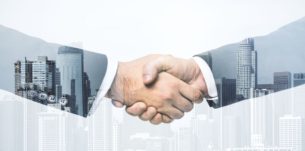 Handshake of two businessmen on modern cityscape background, deal and trading concept. Multiexposure